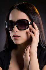 Woman in sunglasses. Attractive young woman in sunglasses lookin