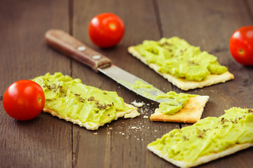 Avocado cream,biscuits and small tomatoes