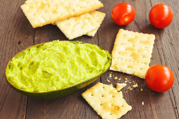 Avocado cream,biscuits and small tomatoes
