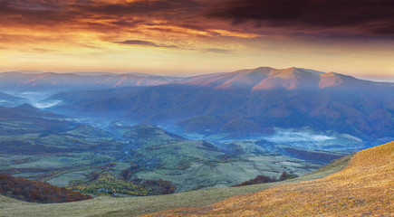 Panorama of the dramatic autumn sunset in the mountain