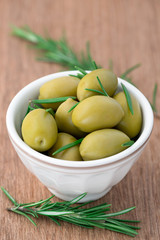 Olives with rosemary in a ceramic bowl