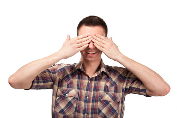 Man in plaid shirt covering his eyes