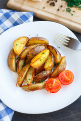 Fried potato wedges with cherry tomato