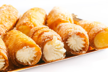 combs and honey pastry filled with cream, golden tray