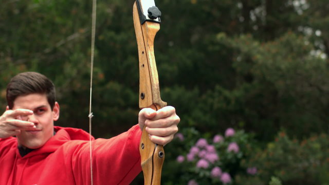 Man shooting bow and arrow