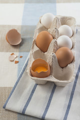 White and brown eggs in a paper holder