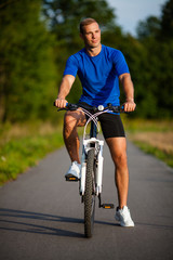 Healthy lifestyle - young man biking