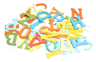 Old, colorful, plastic letters on white background