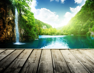 waterfall in deep forest of croatia and wood pier