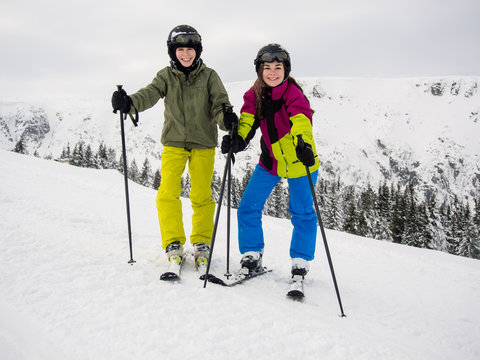 Teenage girl and boy skiing