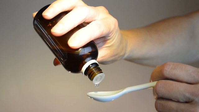 drop medicine on white spoon bright
