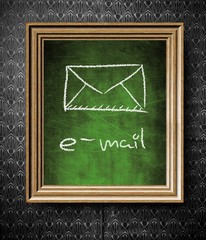 E-mail symbol chalkboard in old wooden frame