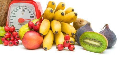 Fruit and kitchen scales on a white background