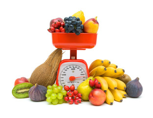 Kitchen scales and fresh fruit isolated on white background
