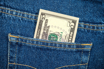 Five dollar bill in the back jeans pocket