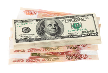 Stack of dollar bills laying over rouble background
