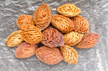 Yellow and red peach kernels on a cellophane background