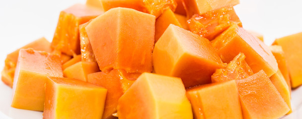 Bite size papaya fruits over white background