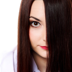 Woman covers part of face by straight long hair