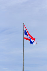 Waving Thai flag with blue sky background 