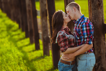 couple on the farm stading near fence