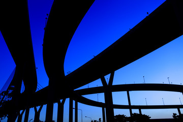 silhouette expressway many routes overlap sunset background