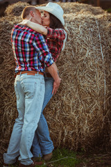Naklejka na ściany i meble couple kissing near hay
