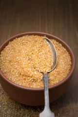 brown sugar in a bowl and spoon, selective focus, close-up