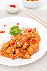chicken fillet in tomato sauce with sesame seeds and rice