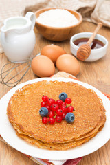 crepes with berries and ingredients for baking