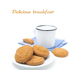 plate of oatmeal cookies and mug of milk isolated