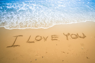 written in a sandy tropical beach