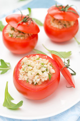 tomatoes stuffed with tuna salad, bulgur and greens, top view