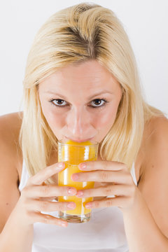 Beautiful women drink orange juice