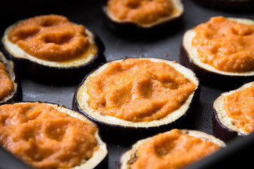 Slice of fried eggplant with orange tomato sauce, cooking tasty