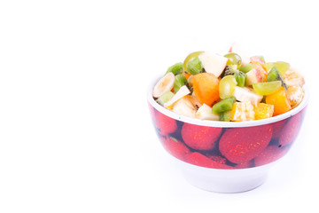 Plate of a tasty cuted fruits isolated on a white background.