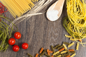 Fototapeta na wymiar pasta, tomatoes and flour on the spoon