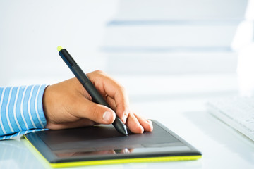 close-up of a man's hand with a pen stylus