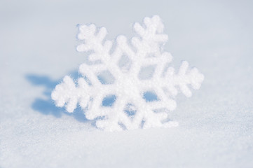 big snowflake toy in snowdrift