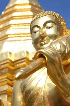 Face of buddha statue with golden pagoda