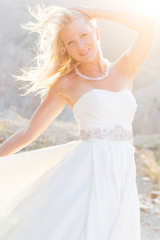 Fototapeta na wymiar Beautiful bride posing on the mountain