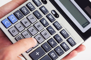 Hand with calculator.