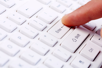 Finger with a computer keyboard.