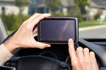 Car driver hands with GPS.