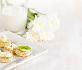 Several canapes and glass of milk