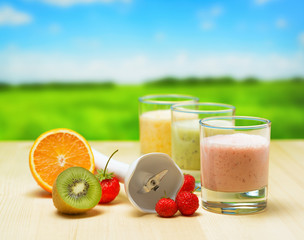 Fruit smoothie on wooden table on rural background