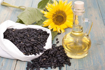 Obraz na płótnie Canvas Sunflower seeds in the bag, and sunflower oil in a bottle