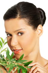 Woman with health skin and with olive tree