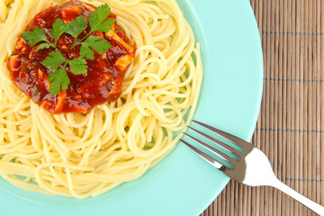 Italian spaghetti in plate on bamboo mat