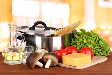 Ingredients for cooking pasta on table in kitchen